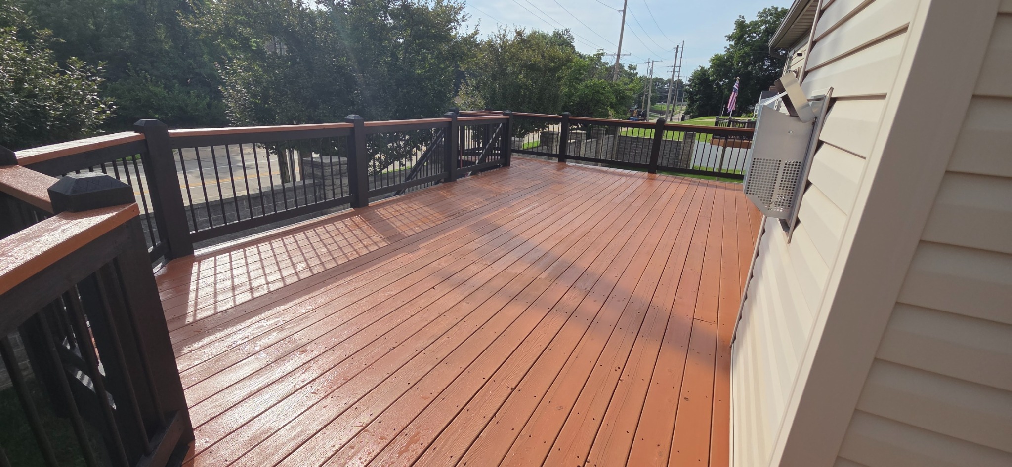 Completed upper deck with coordinated railings and a spacious newly finished deck surface